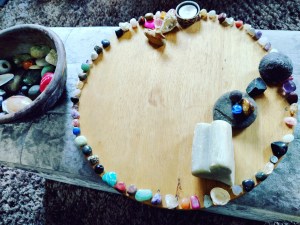 Family Constellation on a round board with semi-precious stones and other items.